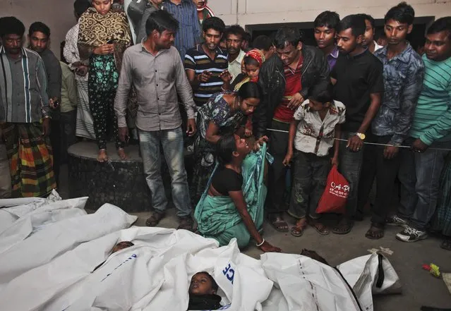 A Bangladeshi relative wails near bodies of victims after a river ferry carrying unto 140 passengers capsized Sunday after being hit by a cargo vessel,in Manikganj district, about 40 kilometers (25 miles) northwest of Dhaka, Bangladesh, Sunday, February 22, 2015. (Photo by A. M. Ahad/AP Photo)