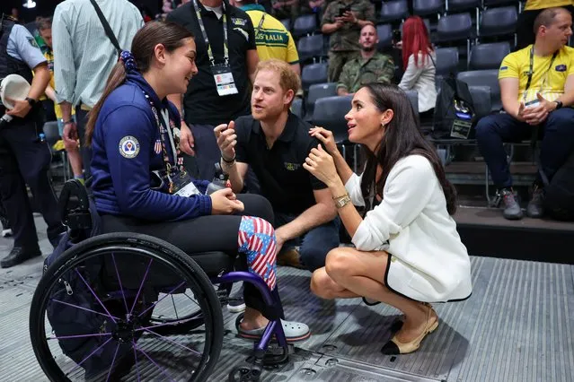 Prince Harry, Duke of Sussex and Meghan, Duchess of Sussex talk with Annika Hutsler of USA as they attend the Wheelchair Basketball preliminary match during day four of the Invictus Games Düsseldorf 2023 on September 13, 2023 in Duesseldorf, Germany. (Photo by Chris Jackson/Getty Images for the Invictus Games Foundation)
