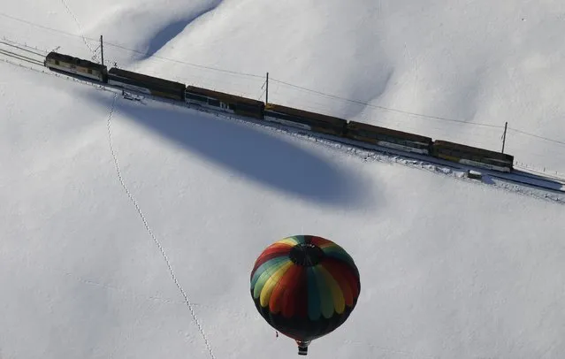 A balloon flies during the 38th International Hot Air Balloon Week in Chateau-d'Oex, Switzerland January 23, 2016. For nine days balloonists from 15 countries take part in the ballooning event in the Swiss mountain resort famous for ideal flight conditions due to an exceptional microclimate. (Photo by Denis Balibouse/Reuters)