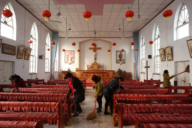 Members of the congregation clean the unofficial catholic church after Sunday service in Majhuang village, Hebei Province, China, December 11, 2016. (Photo by Thomas Peter/Reuters)