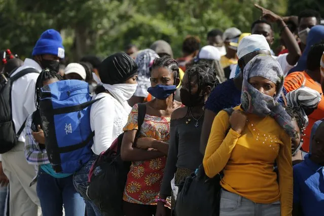 People waiting for days to apply for visas wait outside the U.S. embassy where they were told the embassy continues to be closed in Port-au-Prince, Haiti, Monday, July 12, 2021. (Photo by Fernando Llano/AP Photo)