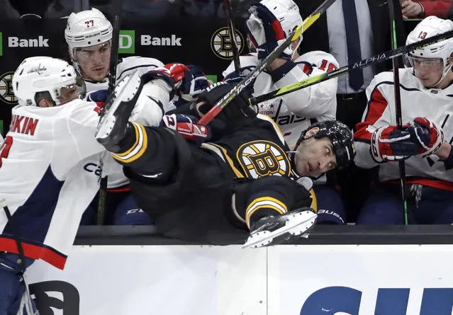 Boston Bruins defenseman Zdeno Chara is checked into the Washington Capitals bench by Washington Capitals left wing Alex Ovechkin, left, during the first period of an NHL hockey game Thursday, January 10, 2019, in Boston. (Photo by Elise Amendola/AP Photo)