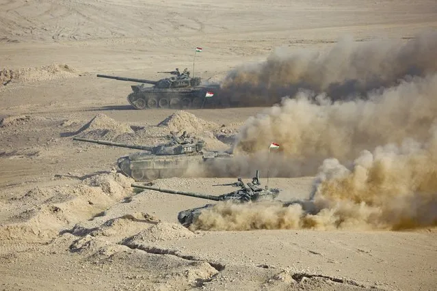 Tajikistan's tanks roll during a joint military drills by Russia and Uzbekistan at Harb-Maidon firing range about 20 kilometers (about 12 miles) north of the Tajik border with Afghanistan, in Tajikistan, Tuesday, August 10, 2021. The troops from Russia, Tajikistan and Uzbekistan on Tuesday wrapped up their drills intended to simulate a joint response to potential security threats coming from Afghanistan. The war games that began last week involved 2,500 Russian, Tajik and Uzbek troops and about 500 military vehicles. (Photo by Didor Sadulloev/AP Photo)