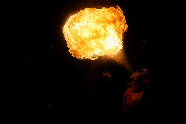 A fire breather performs during a parade known as “La Calabiuza” to celebrate the Day of the Dead in Tonacatepeque, El Salvador on November 4, 2023. (Photo by Jose Cabezas/Reuters)