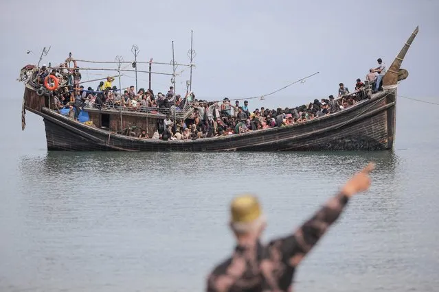 Newly arrived Rohingya refugees are stranded on a boat after the nearby community decided not to allow them to land after giving them water and food in Pineung, Aceh province on November 16, 2023. (Photo by Amanda Jufrian/AFP Photo)