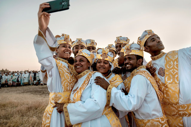 Ethiopian Orthodox christians take a selfie during the annual celebration of Timkat, the Ethiopian Epiphany, in Jan Meda sports ground in Addis Ababa on January 18, 2019. Timkat is the Ethiopian Orthodox Christian festival which celebrates the baptism of Jesus in the Jordan river. (Photo by Eduardo Soteras/AFP Photo)