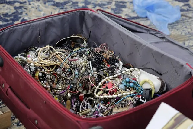 In this April 16, 2015 photo, costume  jewelry is on display for sale at al-Aqeeliya open-air auction market in Riyadh, Saudi Arabia. A man came with the suitcase full of beaded jewelry and sold the whole bag to the auction winner, who had just a few moments to inspect its contents before buying. (Photo by Hasan Jamali/AP Photo)