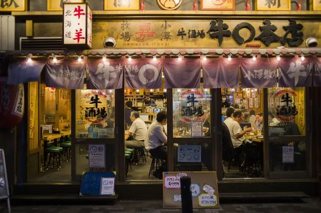People eat and drink at a restaurant before 8 p.m., the closing time suggested by the government for the ongoing state of emergency in Tokyo, Thursday, September 30, 2021. On Friday, Oct. 1, 2021, Japan fully came out of a coronavirus state of emergency for the first time in more than six months as the country starts gradually easing virus measures to help rejuvenate the pandemic-hit economy as the infections slowed. (Photo by Hiro Komae/AP Photo)