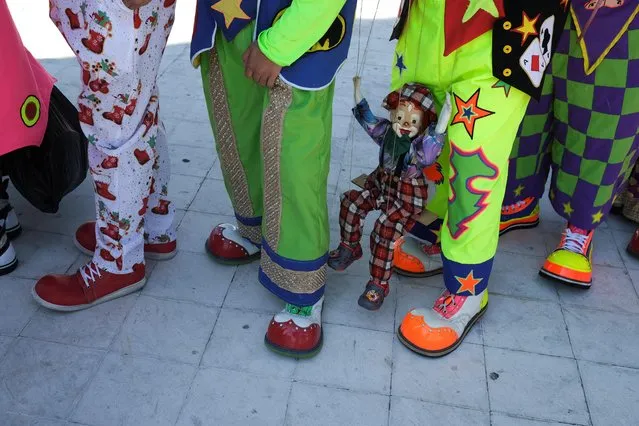 Salvadoran clowns prepare to participate in a parade during National Clown Day celebrations in San Salvador, El Salvador on December 7, 2022. (Photo by Jose Cabezas/Reuters)