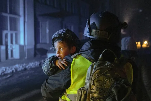 A policeman carries a little boy at the site of an overnight Russian rocket attack in Kharkiv, Ukraine, 16 January 2024(Issued 17 January). At least 17 people were injured as a result of two rockets hitting the downtown area of the eastern Ukrainian city of Kharkiv, according to the Mayor of Kharkiv, Ihor Terekhov. Russian troops entered Ukrainian territory in February 2022, starting a conflict that has provoked destruction and a humanitarian crisis. (Photo by Yakiv Liashenko/EPA/EFE)