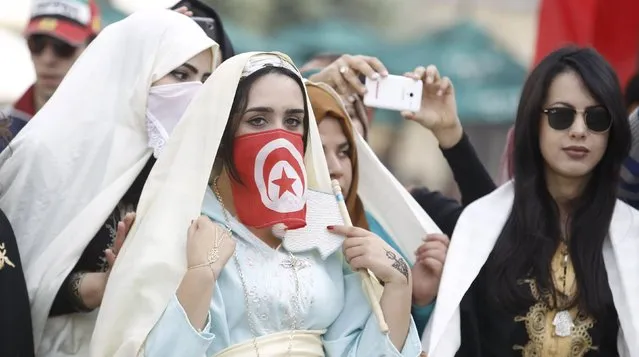 Women wear traditional veils known as “sefseri” on the National Day of Crafts and Traditional Dress in Tunis, Tunisia March 20, 2016. (Photo by Zoubeir Souissi/Reuters)