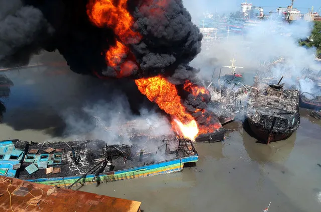 Fishing boats on fire at a harbour in Tegal, Java, Indonesia on November 16, 2021. (Photo by Oky Lukmansyah/Antara Foto via Reuters)