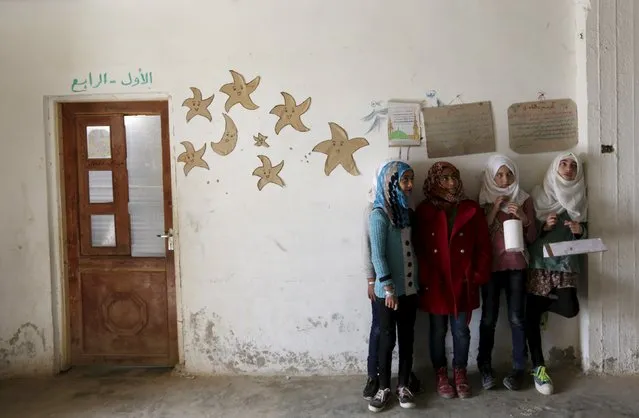 Students hold geometrical forms to decorate the Freedom School, in the town of al-Tamanah, in the southern countryside of Idlib, Syria March 9, 2016. This school was converted from a poultry farm by the residents of the town more than a year ago. (Photo by Khalil Ashawi/Reuters)