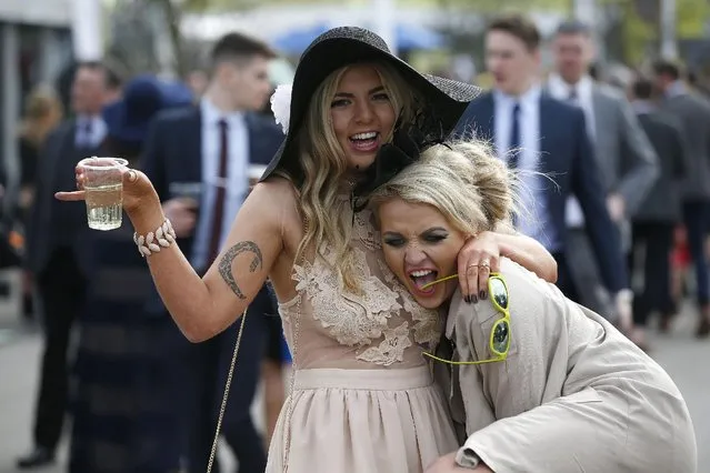 Ladies have fun during Ladies Day of the Crabbie's Grand National Festival at Aintree Racecourse on April 8, 2016 in Liverpool, England. (Photo by Andrew Yates/Reuters/Livepic)