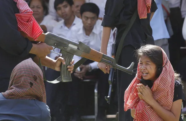 A scene from the notorious “Killing Fields” is re-enacted during a ceremony at the Choeung Ek Genocidal Center in Phnom Penh, Cambodia, 20 May 2015. Cambodia marks the annual Anger Day on 20 May to commemorate the victims who died during the cruel rule of the Khmer Rouge regime from 1975-1979. Some two million Cambodians are estimated to have died by starvation and forced labour or were killed in politically justified executions during the Khmer Rouge regime. (Photo by Mak Remissa/EPA)