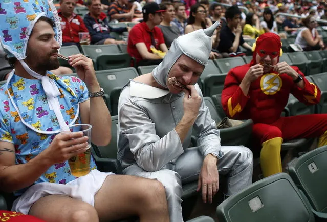 Rugby fans eat chicken wings on the last day of the three-day Hong Kong Sevens rugby tournament as part of the Sevens World Series in Hong Kong March 30, 2014. (Photo by Bobby Yip/Reuters)