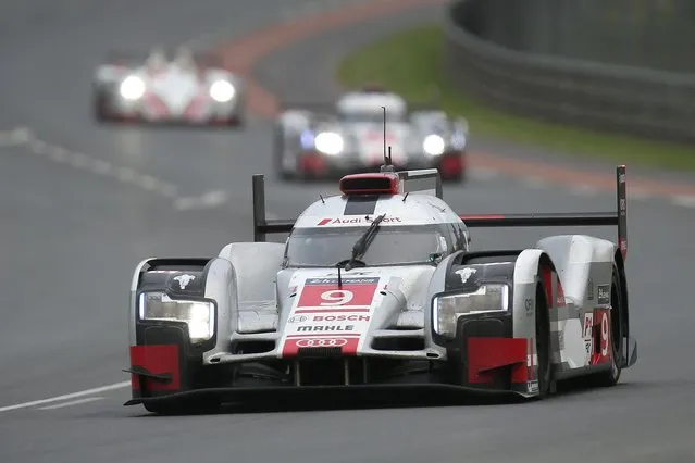 The Audi R18 E-TRON Quattro No9 of the Audi Sport Team Joest driven by Filipe Albuquerque of Portugal, Marco Bonanomi of Italy and Rene Rast of Germany is seen in action during the 83rd 24-hour Le Mans endurance race, in Le Mans, western France, Saturday, June 13, 2015. (AP Photo/David Vincent)