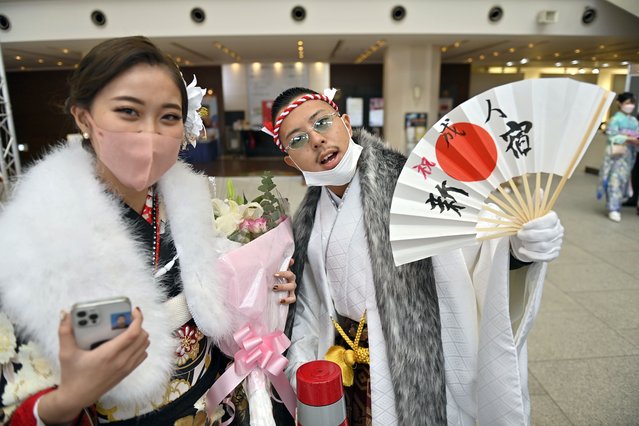 Young adults wearing a mask, attends a ceremony as they commemorates the Coming of Age Day of young people entering adulthood in Tokyo, Japan, on January 10, 2022. While the COVID-19 epidemic continues to progress in Japan due to the new Omicron variant, the events that have been organized by the various municipalities of Tokyo have followed a strict sanitary protocol, such as temperature control, disinfection of hands, and the wearing of a protective mask. (Photo by David Mareuil/Anadolu Agency via Getty Images)
