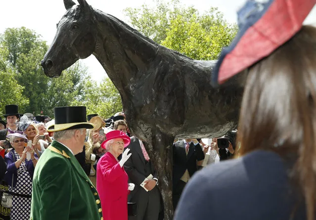 Britain's Queen Elizabeth II looks at the newly unveiled statue to the undefeated racehorse Frankel on the first day of  Royal Ascot horse racing meet at Ascot, England, Tuesday, June 16, 2015. Royal Ascot is the annual five day horse race meeting that Britain's Queen Elizabeth II attends every day of the event. (AP Photo/Alastair Grant)