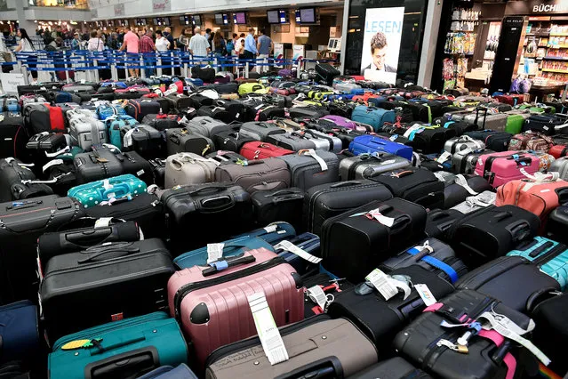 Hundreds of suitcases are left in the check-in area of the international airport in Duesseldorf, Germany, 17 July 2019. A technical malfunction in baggage handling meant numerous travellers had to leave their suitcases at Duesseldorf Airport on 16 July. (Photo by Sascha Steinbach/EPA/EFE)