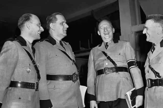 This February 20, 1939 file photo shows Fritz Kuhn, second from left, national leader of the German-American Bund, and Gustave Elmer, third from left, national director of Organization for the Bund, join other uniformed Bundsmen in a last-minute discussion of the Bund rally, at New York's Madison Square Garden.  he pro-Hitler rally that took place 80 years ago this week at New York’s Madison Square Garden is the subject of a short documentary that’s up for an Oscar this Sunday, Feb. 24, 2019. The film directed by Marshall Curry is called a “A Night at the Garden”. (Photo by AP Photo/File)