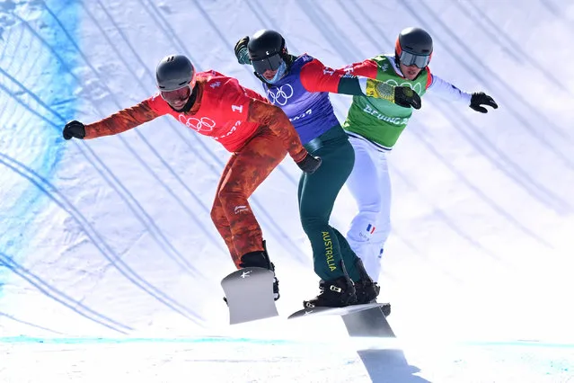 Eliot Grondin of Canada (left) leads Adam Lambert of Australia (centre) and Merlin Surget of France during the 1/8 final round of the Men’s Snowboard Cross at the Genting Snow Park, during the 2022 Beijing Winter Olympic Games, in Beijing, China, Thursday, February 10, 2022. (Photo by Dan Himbrechts/AAP Image)