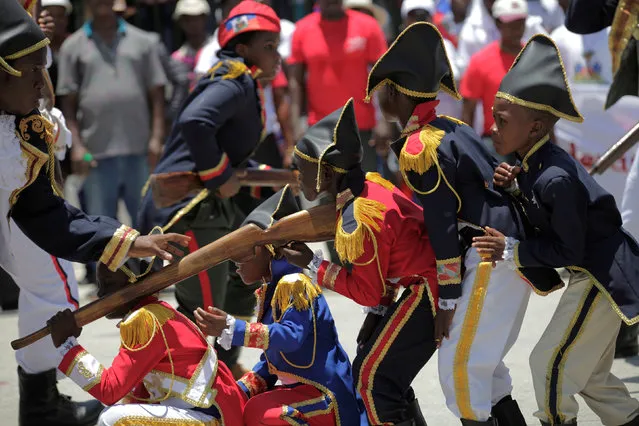 Children and actors participate in a performance during the anniversary celebrations of Haiti's National flag day in Arcahaie, Haiti, May 18, 2016. (Photo by Andres Martinez Casares/Reuters)