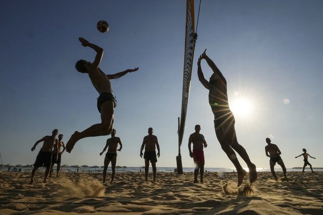 Men playing beach volley ball on a sweltering hot day, at the Ramlet al-Baida public beach in Beirut, Lebanon, Tuesday, July 16, 2024. (Photo by Hassan Ammar/AP Photo)