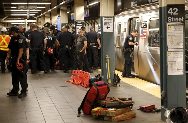 New York City Police and Fire Department emergency staff work on the “N” subway platform after a man was apparently struck by a southbound “N” subway train in the Times Square station in New York City, July 17, 2015. (Photo by Mike Segar/Reuters)