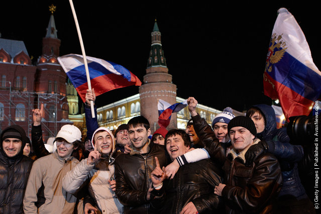 Supporters listen as Russian Prime Minister and presidential candidate Vladimir Putin speaks during a rally after Putin claimed victory in the presidential election at the Manezhnya Square March, 4, 2012 in Moscow, Russia