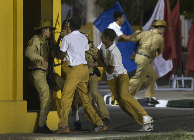 Students reenact a 1953 attack on the Moncada barracks during an event celebrating the Revolution Day in Santiago, Cuba, Sunday, July 26, 2015. Cuba marks the 62st anniversary of the July 26, 1953 rebel attack led by Fidel and Raul Castro on the Moncada military barracks. The attack is considered the beginning of Fidel Castro's revolution that culminated with dictator Fulgencio Batista's ouster. (Photo by Ramon Espinosa/AP Photo)