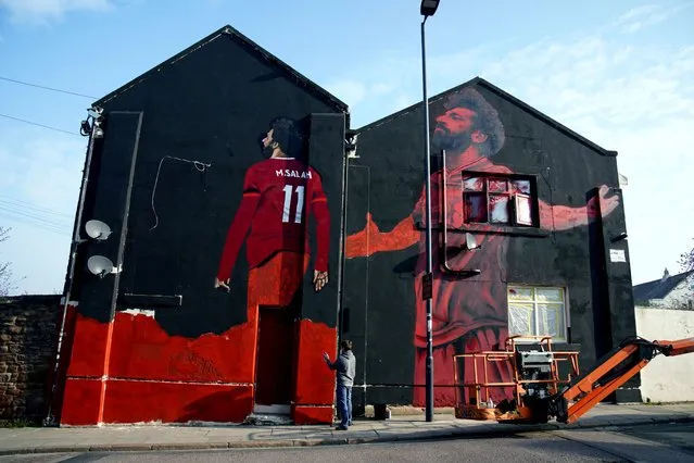 A mural by local artist John Culshaw (pictured) of Liverpool player Mohamed Salah, Anfield Road, Liverpool on Tuesday, March 29, 2022. (Photo by Peter Byrne/PA Images via Getty Images)