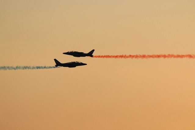 French Air and Space Force's elite acrobatic flying team “Patrouille de France'” releases trails of blue, white and red smokes, representing the French national flag's colours in Versailles, on June 26, 2024, during a rehearsal of the ceremony marking the 90th anniversary of French Air and Space Force. Formed in 1909 as the Service Aeronautique, a service arm of the French Army, it became an independent military branch in 1934 as the French Air Force. (Photo by Dimitar Dilkoff/AFP Photo)