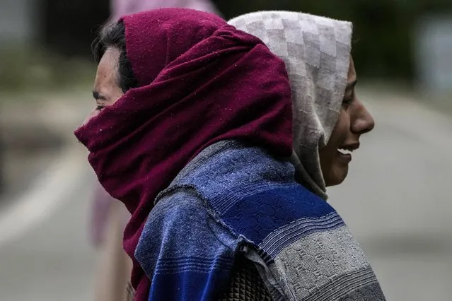 Two Kashmiri women cry after their house was damaged in a gun-battle between government forces and suspected rebels in Malwah village, north of Srinagar, Indian controlled Kashmir, Thursday, April 21, 2022. According to officials two suspected rebels were killed and four soldiers and a policeman injured during the ongoing gun-battle. (Photo by Mukhtar Khan/AP Photo)