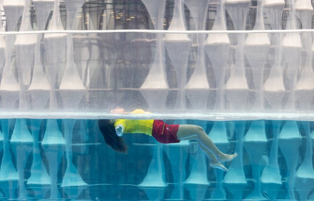 Courtney Randino, an RNLI lifeguard, demonstrates the “float to live” technique at the Embassy Gardens Skypool in London on May 21, 2024. The organisation hopes to educate people on floating to catch their breath after getting into difficulty in the water. (Photo by Nathan Williams/RNLI)