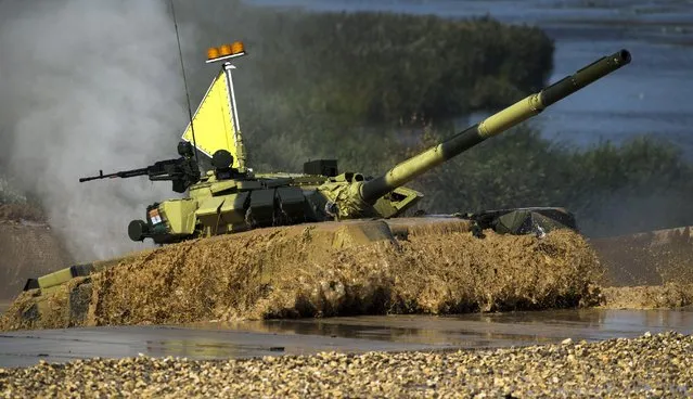 An Indian tank emerges from the water during competition in Alabino, outside Moscow, Russia, Monday, August 3, 2015. (Photo by Pavel Golovkin/AP Photo)