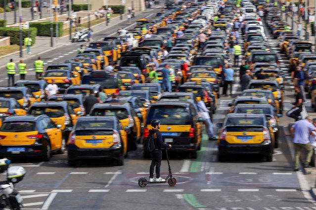 Taxi drivers protest after the Court of Justice of the European Union rejected rules set by the city of Barcelona that dramatically restrict the number of cars working with ride-hailing apps, in Barcelona, Spain on June 14, 2023. (Photo by Nacho Doce/Reuters)