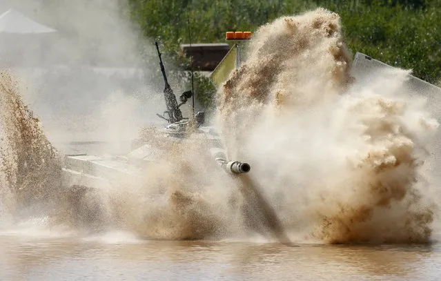 A tank drives through the course of the Tank Biathlon competition during the International Army Games-2015 in Alabino, outside Moscow, Russia, August 4, 2015. (Photo by Maxim Zmeyev/Reuters)