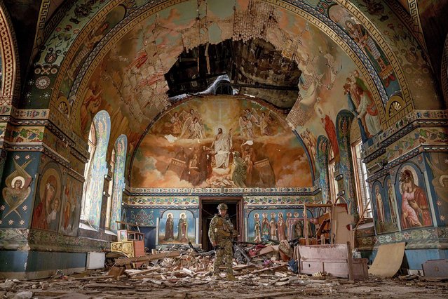 Ukrainian serviceman Gennadiy Yudin stands inside orthodox church heavily damaged by a Russian bombing in Novoekonomichne, Ukraine, Tuesday, September 17, 2024. (Photo by Evgeniy Maloletka/AP Photo)