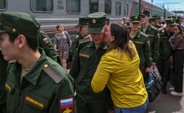 A woman reacts as a conscript, wearing a military uniform, boards a train carriage at a local railway station during departure for the garrisons, in Omsk, Russia on June 17, 2022. (Photo by Alexey Malgavko/Reuters)