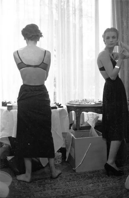 1953: Backstage, British models getting ready for a fashion show by John Cavanagh