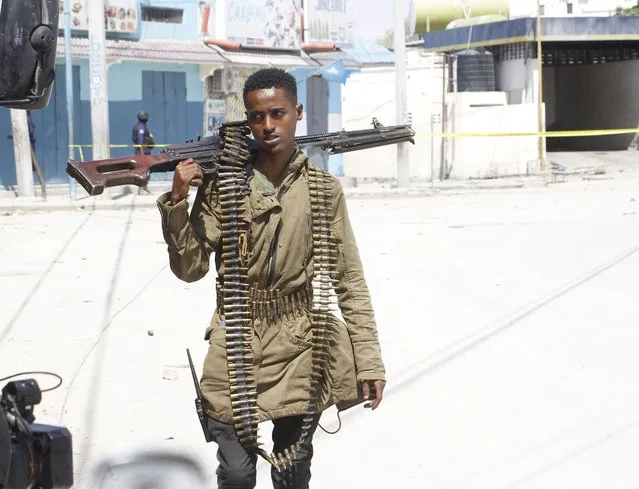 A soldier patrols outside the Hayat Hotel in Mogadishu, Somalia, Saturday August 20, 2022. At least 10 people were killed in an attack by Islamic militants who stormed the hotel in Somalia's capital late Friday, police and eyewitnesses said. Several other people were injured and security forces rescued many others, including children, from the scene of the attack at Mogadishu's Hayat Hotel. (Photo by Farah Abdi Warsameh/AP Photo)