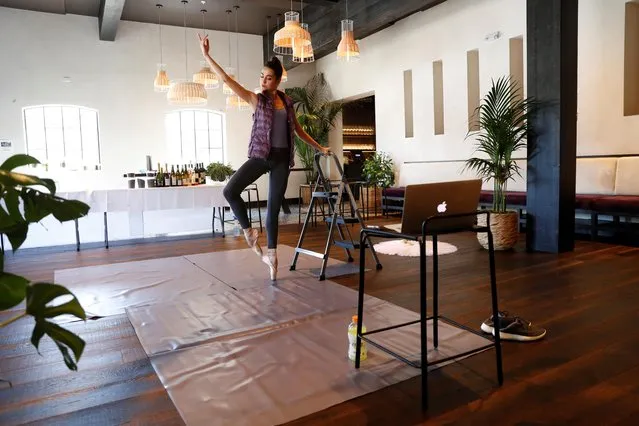 Mathilde Froustey, principle dancer of San Francisco Ballet, practices virtually with her ballet company in an empty dining room at her husband Mourad Lahlou’s restaurant, Aziza, as the spread of the coronavirus disease (COVID-19) continues in San Francisco, California, U.S. April 7, 2020. (Photo by Stephen Lam/Reuters)