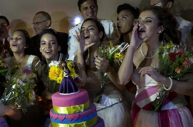 Girls celebrate during their group debutante ball. (Photo by Silvia Izquierdo/AP Photo via The Palm Beach Post)