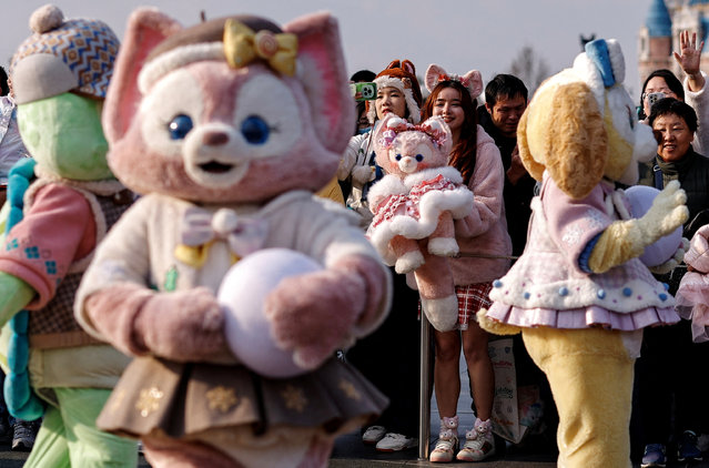 Ida Jia, 29, holds a plush doll of LinaBell, a pink fox character from the Disney series “Duffy and Friends”, during a parade at Shanghai Disneyland, in Shanghai, China on December 23, 2024. (Photo by Tingshu Wang/Reuters)