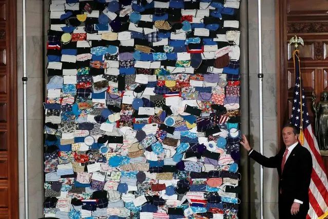New York Governor Andrew Cuomo unveils a mural made up of hundreds of protective face masks sent to New York State from people all across the United States during the outbreak of the coronavirus disease (COVID-19) at the State Capitol in Albany, New York, U.S., April 29, 2020. (Photo by Mike Segar/Reuters)