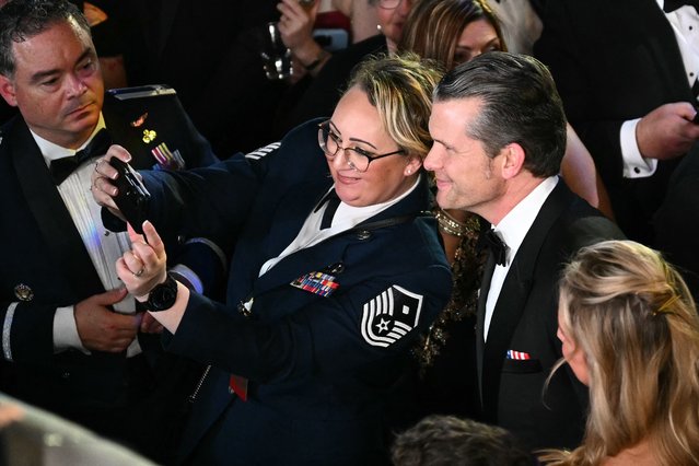 US Secretary of Defense nominee Pete Hegseth (R) poses for a picture with another attendee at the Commander-In-Chief inaugural ball at the Walter E. Washington Convention Center in Washington, DC, on January 20, 2025. (Photo by Patrick T. Fallon/AFP Photo)
