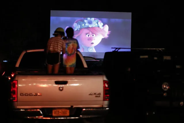 Guests watch a showing of “Trolls World Tour” at the Four Brothers Drive In Theatre, Friday, May 15, 2020, in Amenia, N.Y., during the coronavirus pandemic. (Photo by John Minchillo/AP Photo)