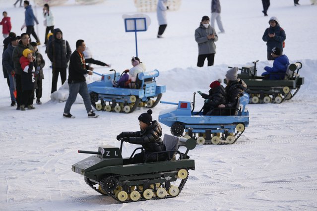 Children ride military tank-styled snow karts at a park made with artificial snow during the Longtan Park Temple Fair on the second day of Lunar New Year in Beijing on Thursday, January 30, 2025. (Photo by Aaron Favila/AP Photo)