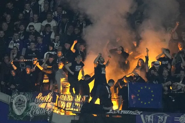 Anderlecht soccer fans set off flares in the stands during the Europa Conference League Group B soccer match between West Ham United and Anderlecht at the London stadium in London, Thursday, October 13, 2022. (Photo by Kirsty Wigglesworth/AP Photo)